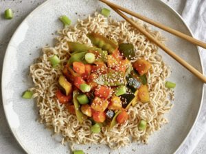 Vegane Tofu-Gemüse-Pfanne süß-sauer auf einem Teller.