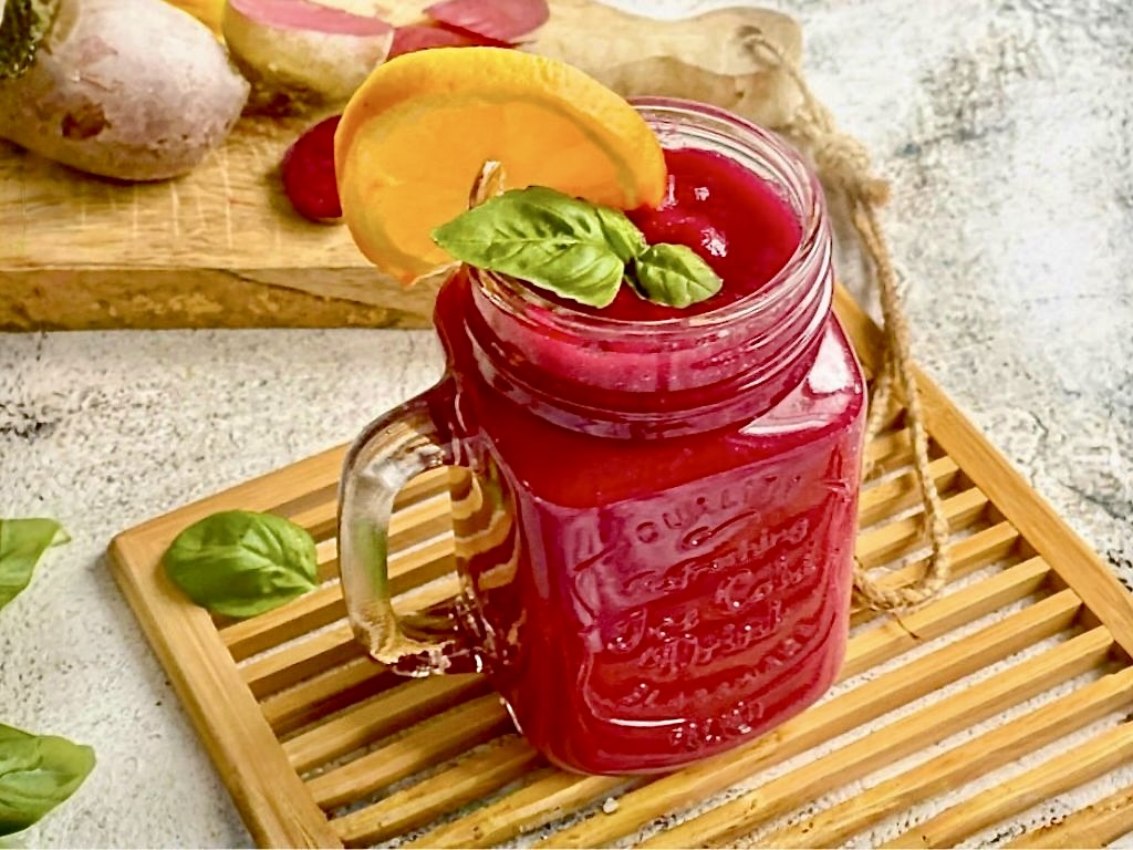 Fruchtig leckerer Rote-Bete-Smoothie in deinem Glas auf einem Holzbrett.