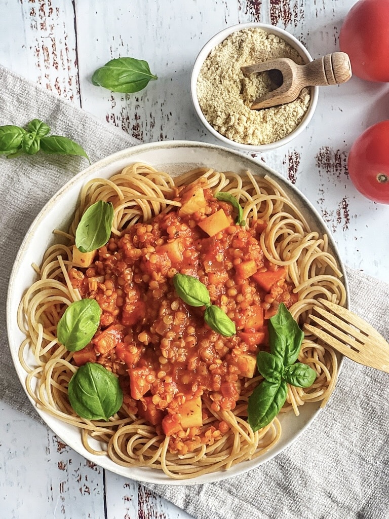 Vegane Linsen-Bolognese mit Spaghetti auf einem Teller.