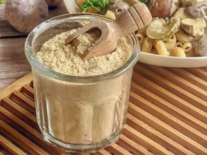 Veganer Parmesan aus Cashewnüssen und Hefeflocken in einem Glas.